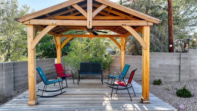 wooden deck with a gazebo and a fenced backyard