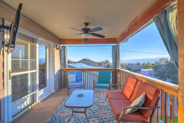 wooden deck featuring ceiling fan and an outdoor living space