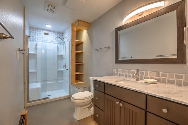 full bath with vanity, a shower stall, toilet, and decorative backsplash