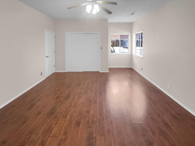 interior space with dark wood-type flooring and ceiling fan