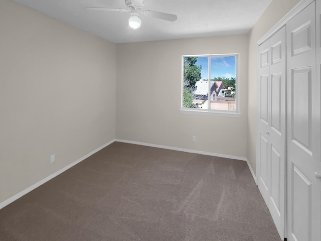 unfurnished bedroom featuring a ceiling fan, carpet, baseboards, and a closet