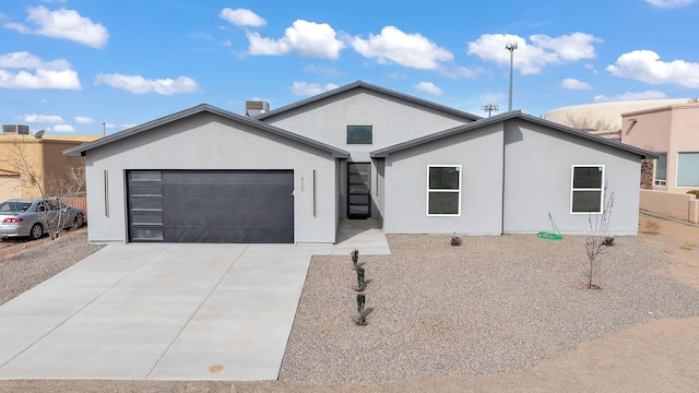 ranch-style house with driveway, stucco siding, and an attached garage