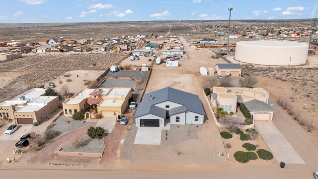 drone / aerial view with view of desert and a residential view