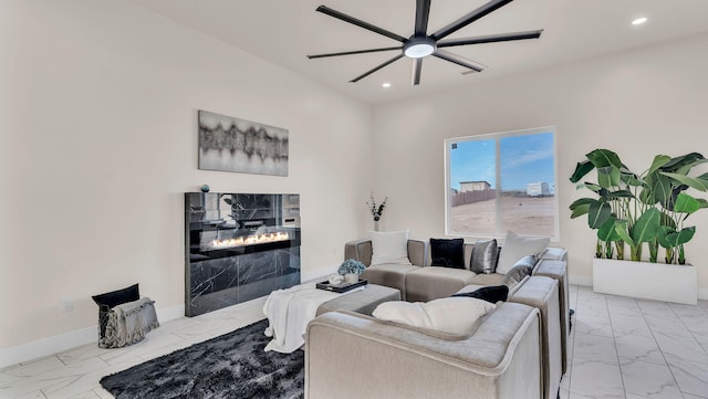 living room with recessed lighting, baseboards, marble finish floor, a ceiling fan, and a fireplace