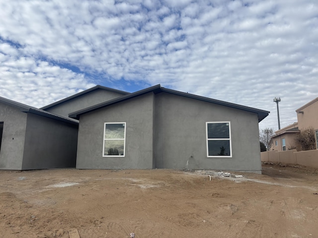 back of house featuring stucco siding