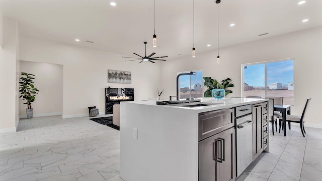 kitchen featuring open floor plan, marble finish floor, recessed lighting, and ceiling fan