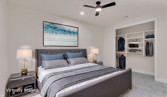 bedroom with a spacious closet, marble finish floor, baseboards, visible vents, and recessed lighting