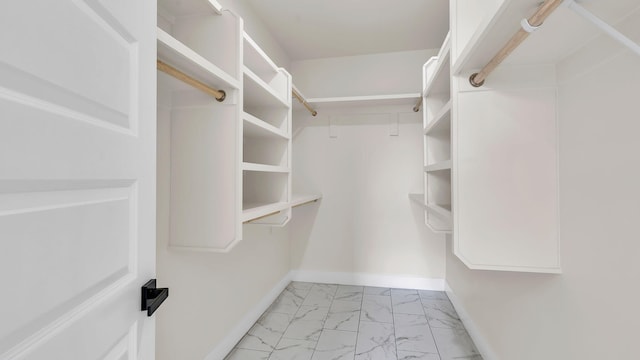 spacious closet with marble finish floor