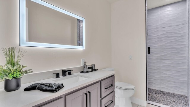 full bathroom with toilet, vanity, and a shower stall