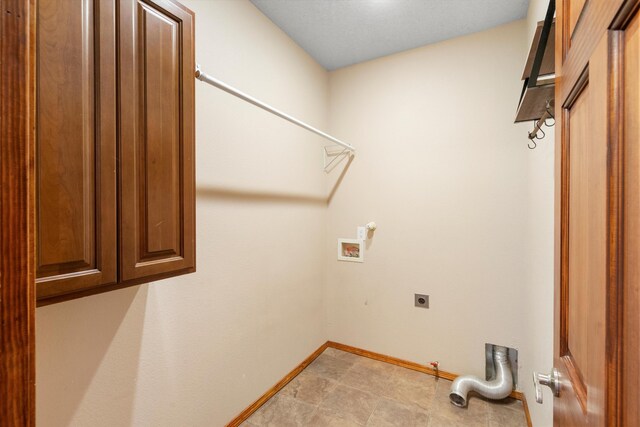 laundry area featuring hookup for an electric dryer, washer hookup, and cabinets