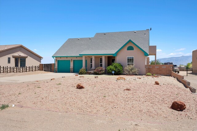 view of front of house with a garage and a mountain view