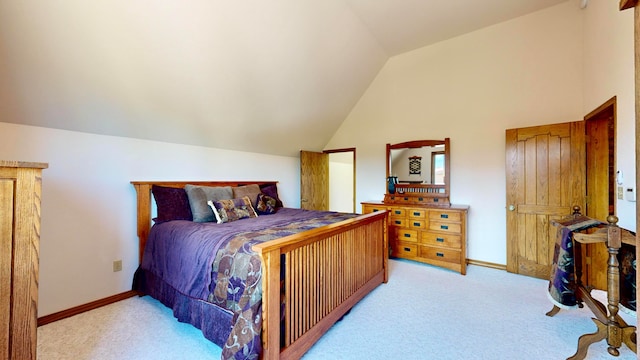 bedroom with light colored carpet and vaulted ceiling