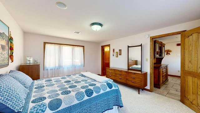 bedroom featuring light colored carpet