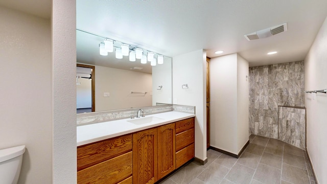 bathroom with vanity, toilet, and tile patterned floors