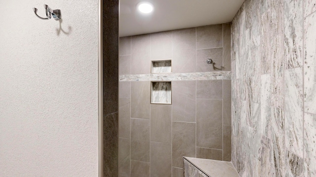 bathroom featuring a tile shower