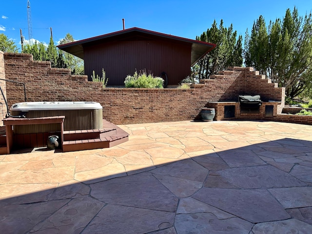 view of patio / terrace with a hot tub and central AC