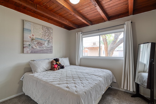 bedroom with wood ceiling, beam ceiling, and carpet