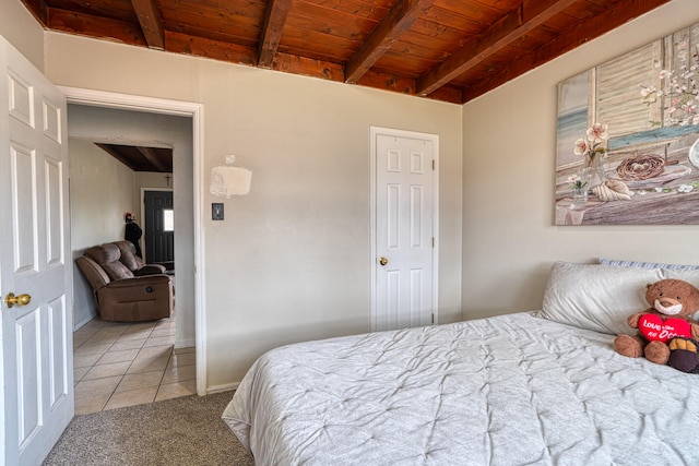 tiled bedroom with wood ceiling and beam ceiling