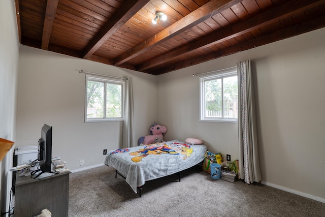 bedroom featuring beamed ceiling, multiple windows, wooden ceiling, and carpet floors