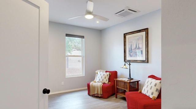 sitting room with wood-type flooring and ceiling fan