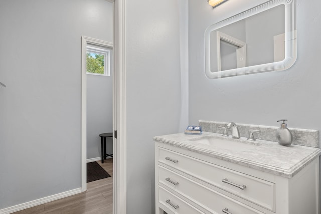 bathroom with vanity and hardwood / wood-style flooring