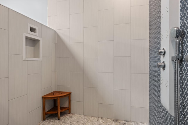 interior details featuring a shower and tile patterned flooring