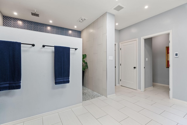 interior space with tile patterned flooring, decorative backsplash, and walk in shower