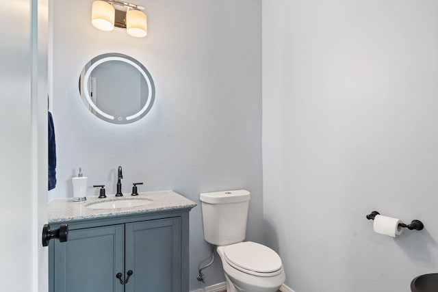 bathroom with toilet and vanity