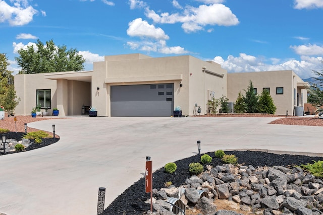 pueblo revival-style home featuring a garage