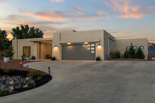 pueblo revival-style home with a garage