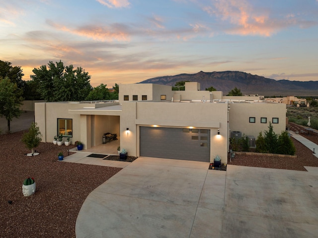 view of front of property featuring a mountain view and a garage