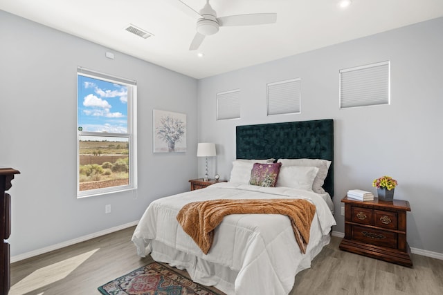 bedroom with ceiling fan and light hardwood / wood-style flooring