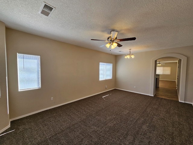 carpeted empty room featuring ceiling fan and a textured ceiling