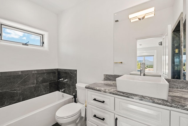 full bathroom with toilet, a wealth of natural light, vanity, and a bath