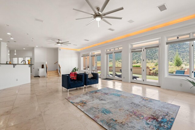 kitchen with a center island with sink, island range hood, sink, ceiling fan, and light tile patterned flooring