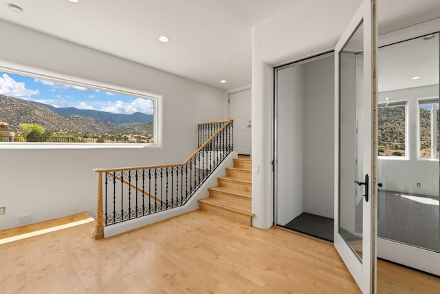 interior space with a mountain view and hardwood / wood-style floors