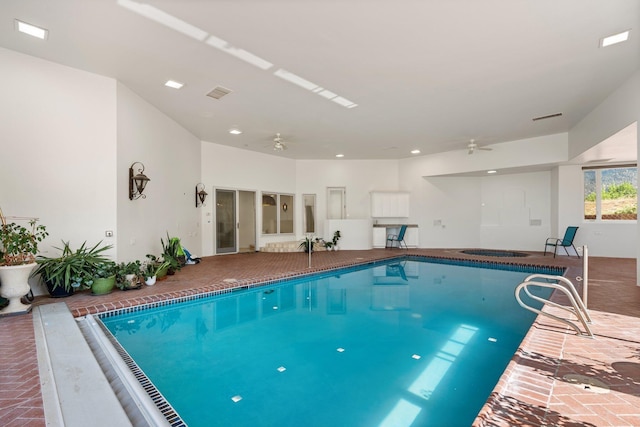 indoor pool featuring ceiling fan