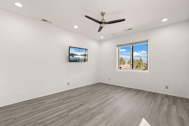 spare room featuring wood finished floors, visible vents, and recessed lighting