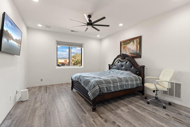 bathroom with a bath, toilet, hardwood / wood-style flooring, and vanity