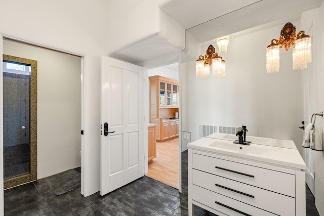 full bath featuring a tile shower and vanity