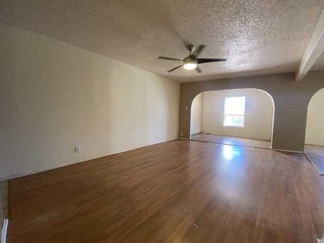 unfurnished room with ceiling fan, hardwood / wood-style floors, and a textured ceiling