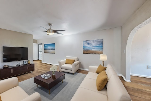 living room with ceiling fan and light hardwood / wood-style flooring