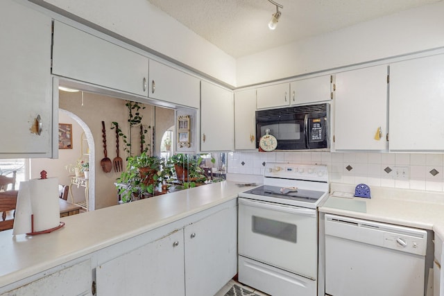 kitchen featuring white appliances, backsplash, white cabinets, and a textured ceiling