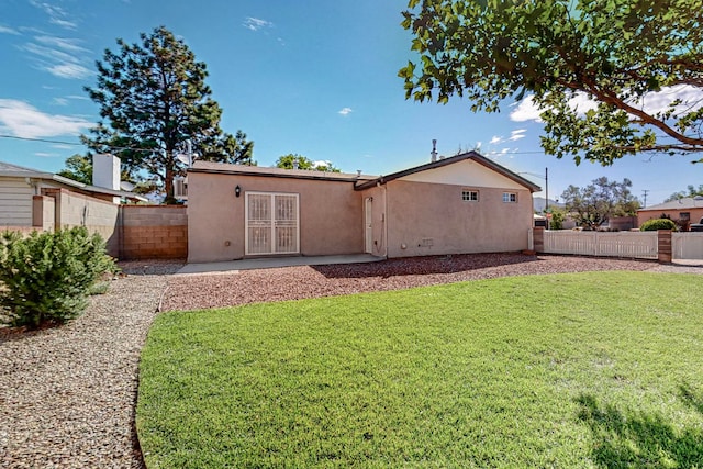 rear view of property with a yard