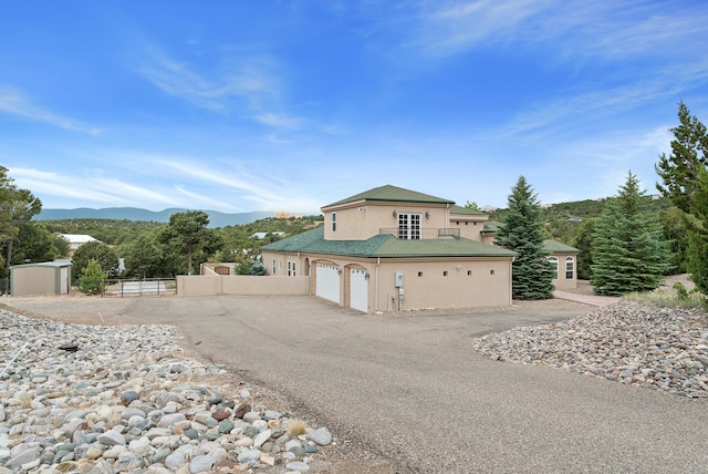 view of front of property featuring a garage and a mountain view