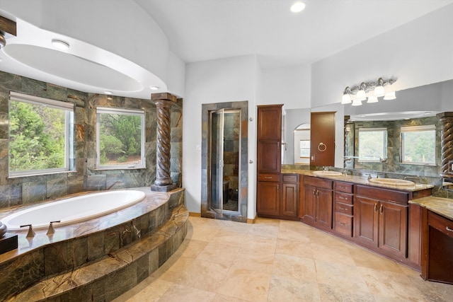 bathroom with vanity and shower with separate bathtub