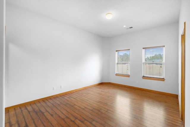 empty room with hardwood / wood-style flooring