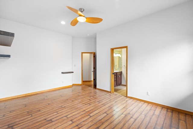 empty room with ceiling fan and light hardwood / wood-style floors