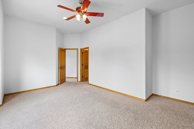 carpeted spare room with ceiling fan