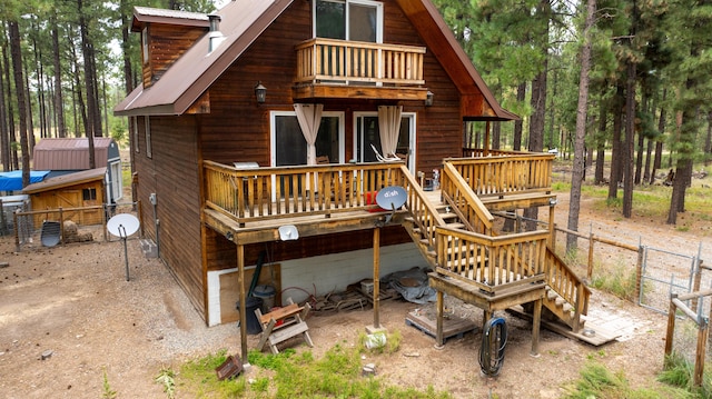 rear view of property with a balcony